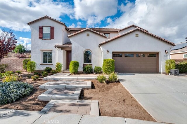 mediterranean / spanish-style house with a garage