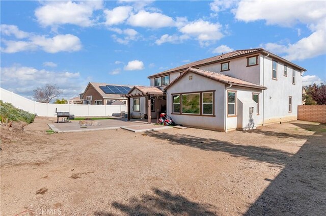 back of property with a patio area