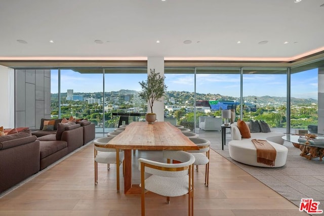 dining space with light wood-type flooring and expansive windows