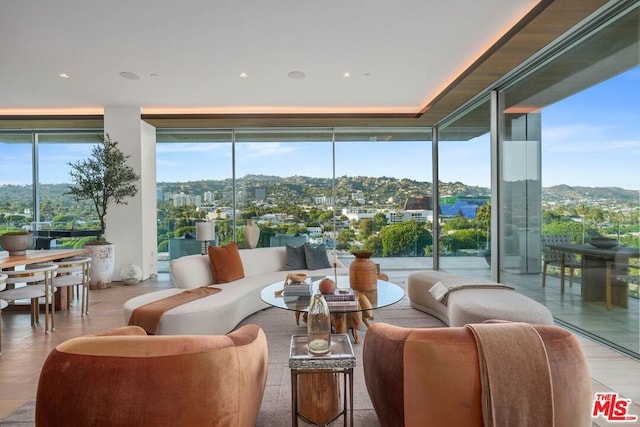 living room with light hardwood / wood-style flooring and floor to ceiling windows