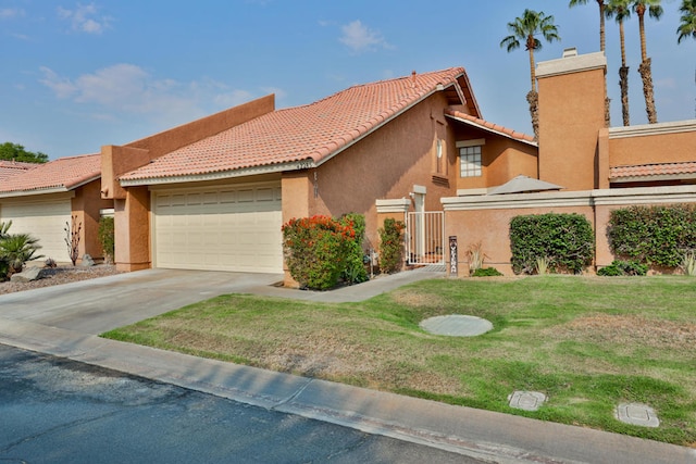 view of front facade featuring a front yard and a garage