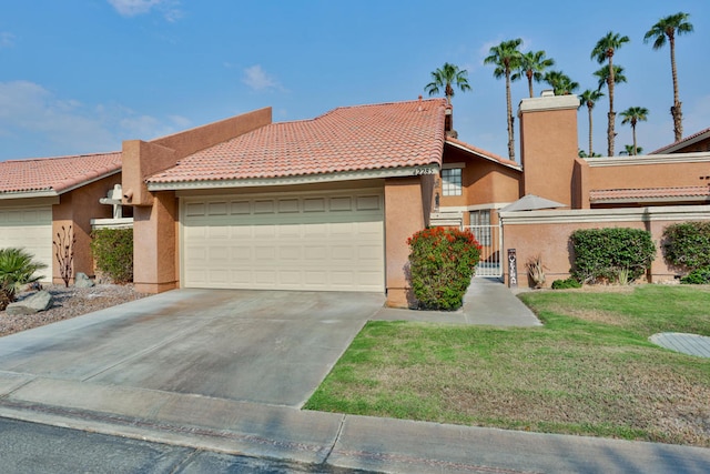 view of front of property with a front yard and a garage