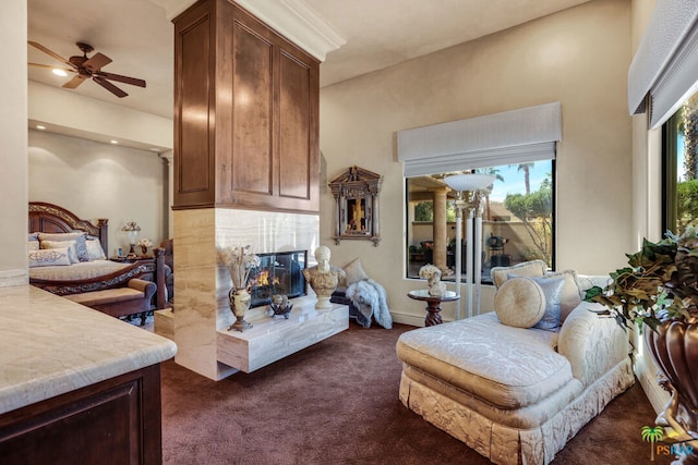 living room featuring dark carpet and ceiling fan