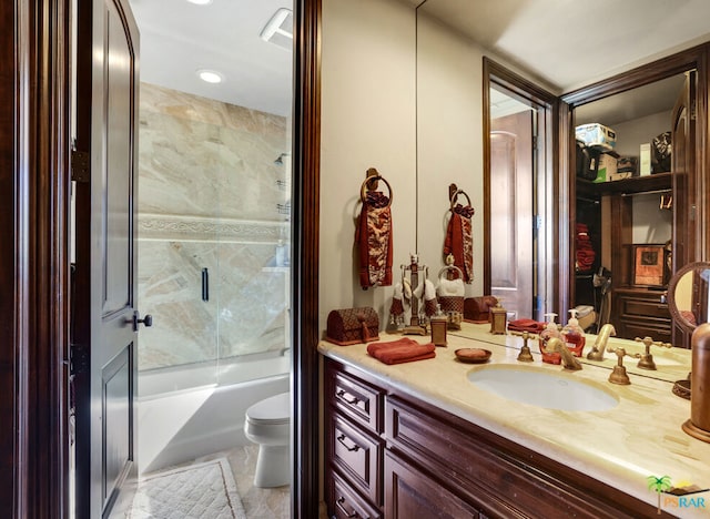 full bathroom featuring enclosed tub / shower combo, vanity, tile patterned flooring, and toilet