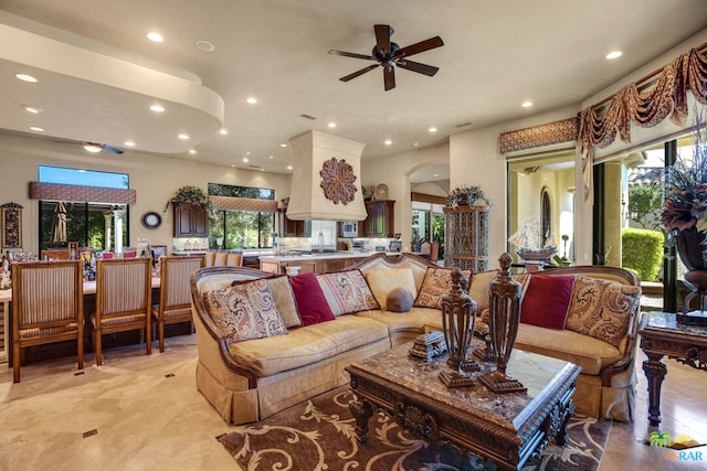 living room featuring ceiling fan and sink