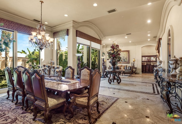 dining space with an inviting chandelier, plenty of natural light, and crown molding