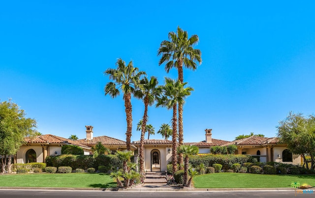 mediterranean / spanish house with a front yard