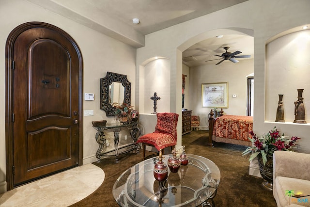 interior space with ceiling fan