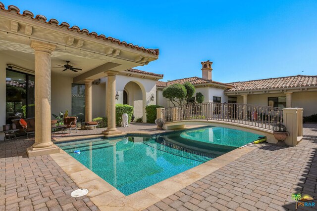 view of swimming pool with ceiling fan and a patio area