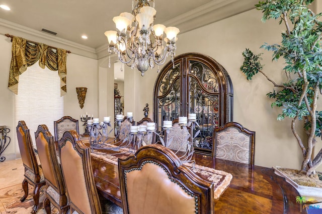 dining space featuring ornamental molding and an inviting chandelier