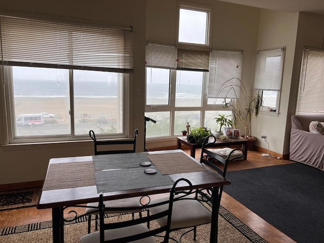 dining room featuring hardwood / wood-style flooring, a water view, and plenty of natural light