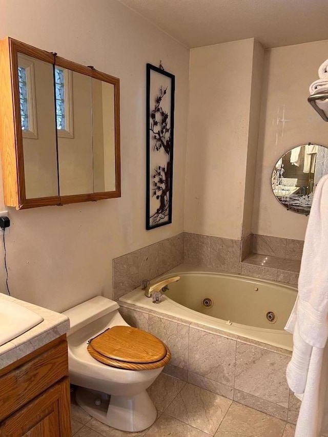 bathroom featuring vanity, toilet, and tiled tub