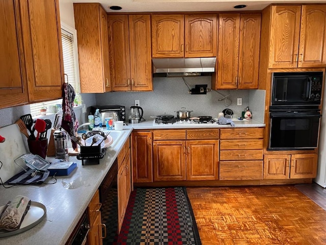 kitchen with sink, decorative backsplash, and black appliances