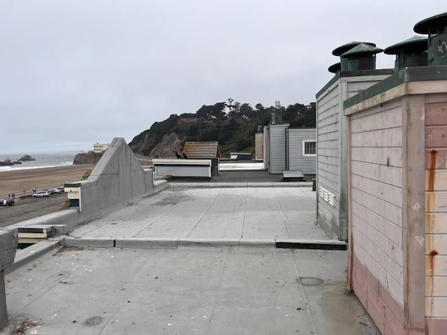 exterior space featuring a water view and a patio area