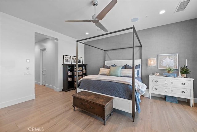 bedroom with light hardwood / wood-style floors and ceiling fan