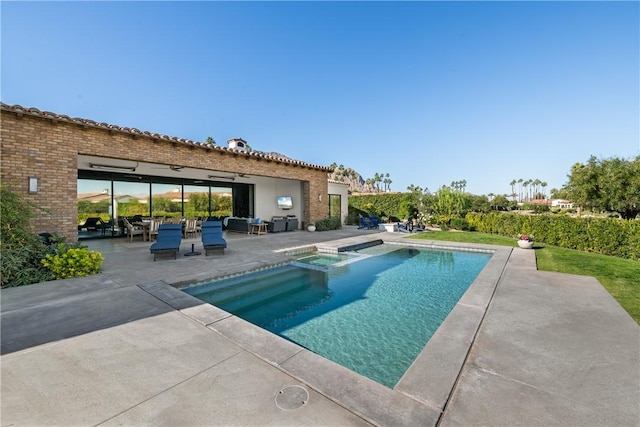 view of swimming pool featuring a patio and an in ground hot tub