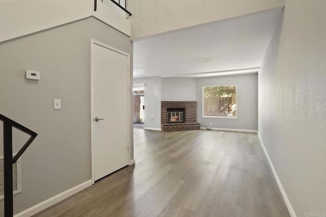 unfurnished living room featuring a fireplace and hardwood / wood-style floors