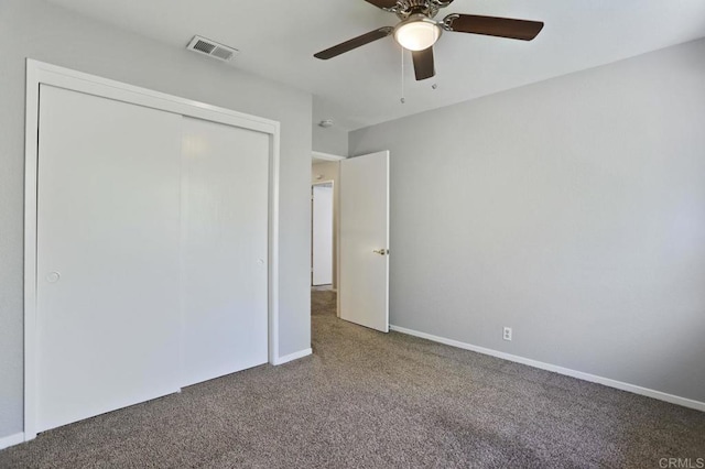 unfurnished bedroom with ceiling fan, a closet, and carpet floors