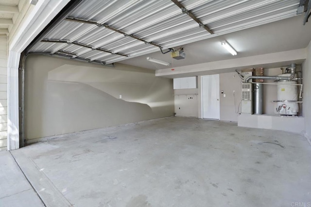 garage with strapped water heater and a garage door opener