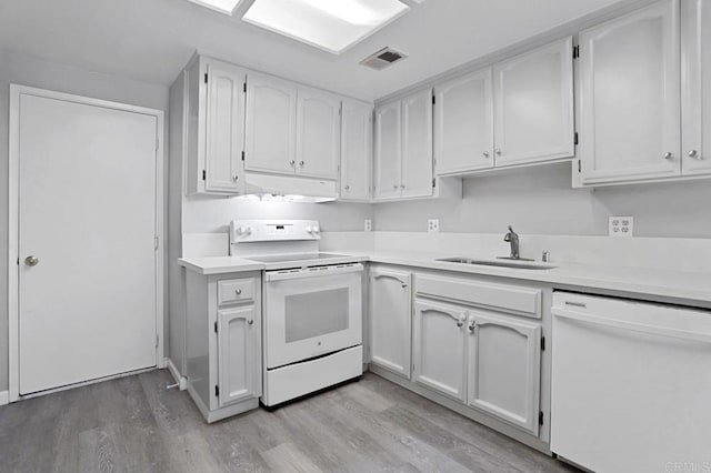 kitchen featuring white appliances, light hardwood / wood-style floors, white cabinetry, and sink