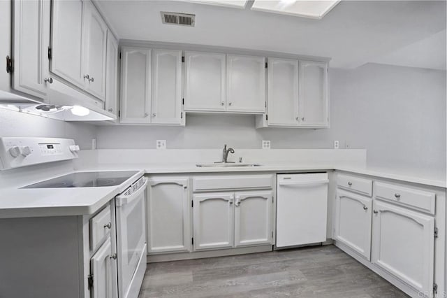 kitchen featuring white cabinets, light wood-type flooring, white appliances, and sink