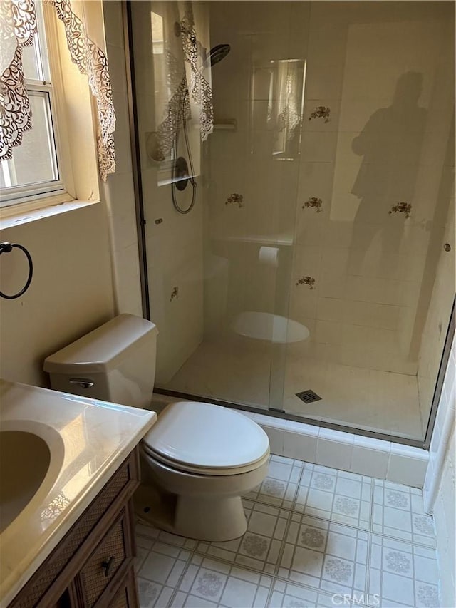 bathroom with vanity, toilet, and an enclosed shower