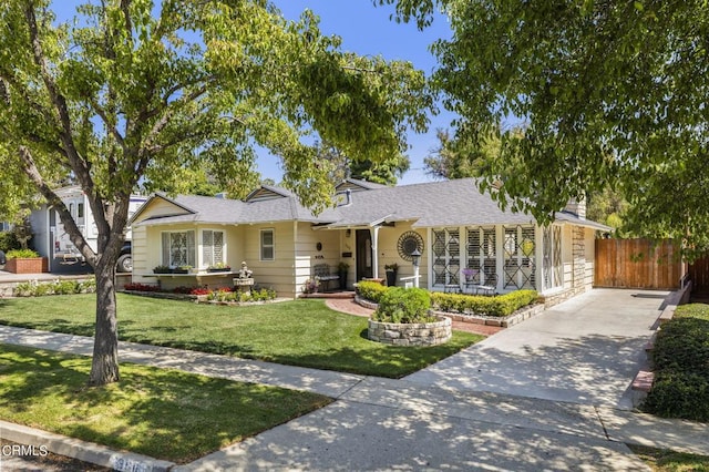 ranch-style home with covered porch and a front yard