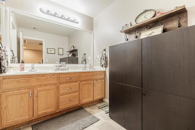 bathroom with tile patterned floors and vanity