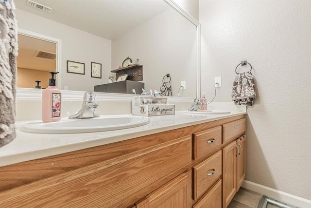 bathroom with tile patterned flooring and vanity