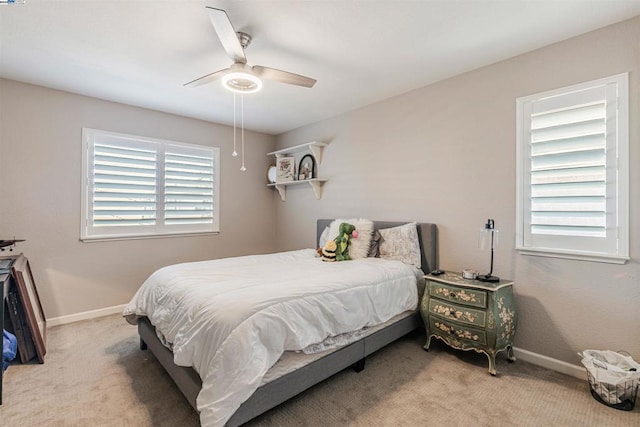 bedroom with ceiling fan and light carpet