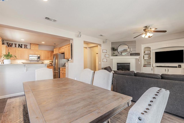 dining room with ceiling fan and light hardwood / wood-style floors