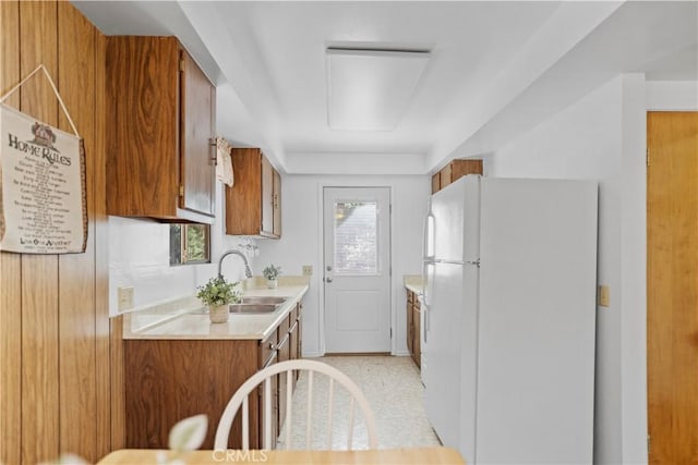 kitchen featuring plenty of natural light, white refrigerator, and sink