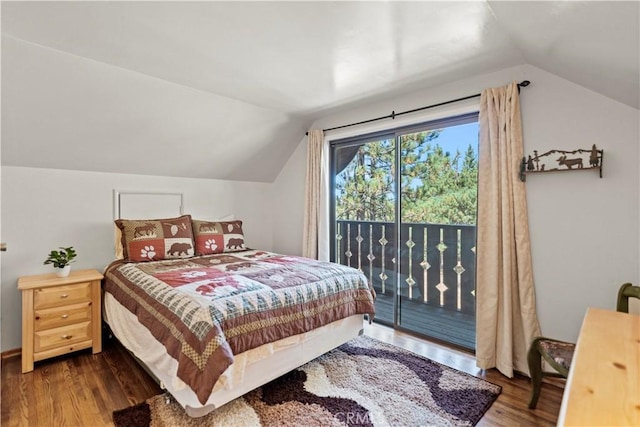 bedroom featuring dark hardwood / wood-style flooring, access to exterior, and lofted ceiling