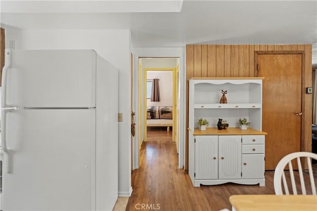 kitchen featuring white refrigerator and light hardwood / wood-style floors