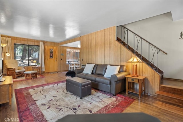 living room featuring wood walls and hardwood / wood-style flooring