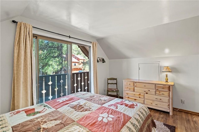 bedroom featuring dark wood-type flooring, access to outside, and vaulted ceiling