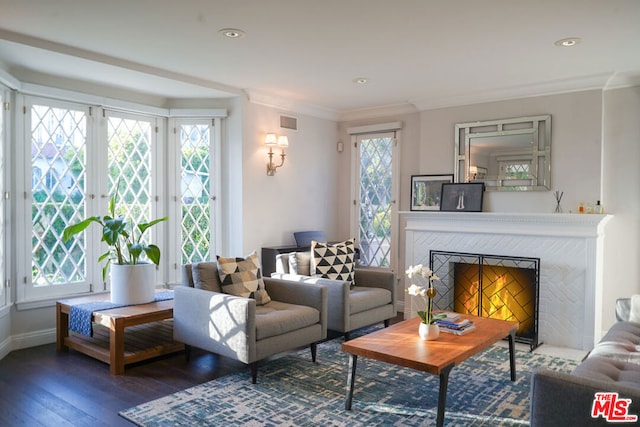 living room with ornamental molding, a fireplace, a healthy amount of sunlight, and hardwood / wood-style flooring