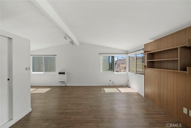 interior space with heating unit, rail lighting, dark wood-type flooring, and vaulted ceiling with beams