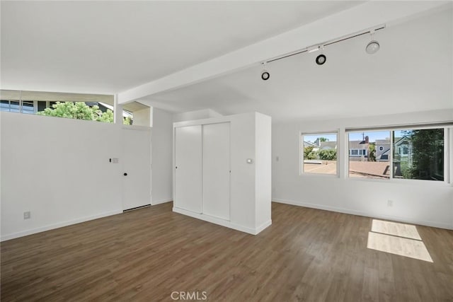 unfurnished living room with lofted ceiling with beams and dark hardwood / wood-style floors