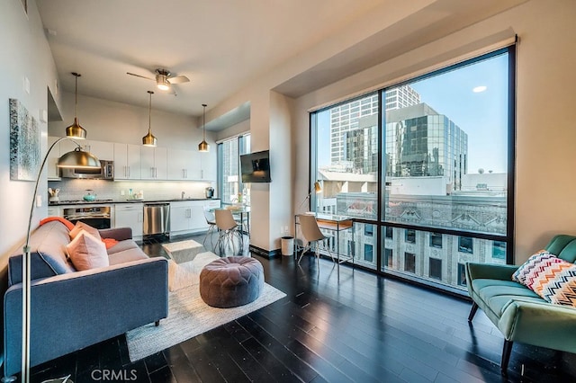 living room with ceiling fan and dark hardwood / wood-style flooring