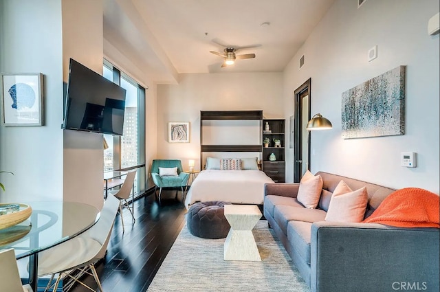 living room featuring ceiling fan and dark hardwood / wood-style floors