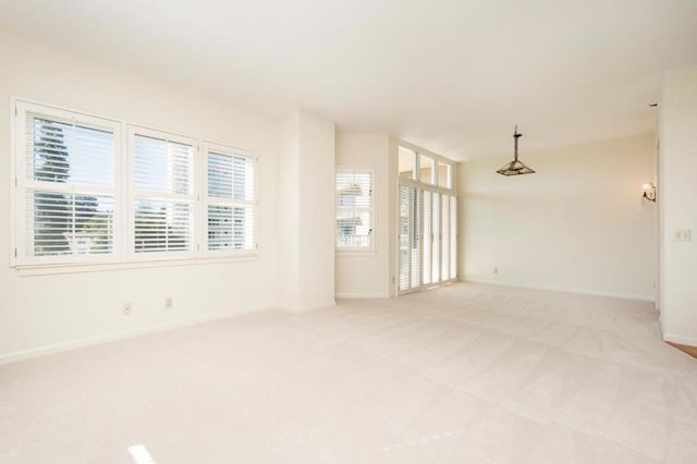 spare room with light colored carpet