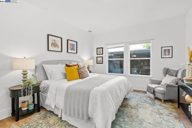 bedroom with hardwood / wood-style flooring