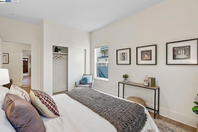 bedroom with a closet and hardwood / wood-style floors