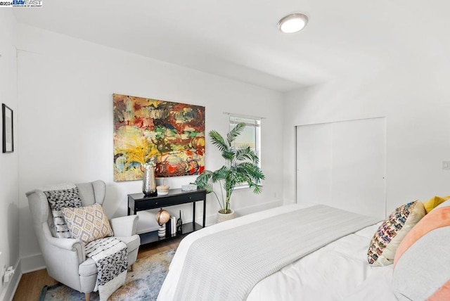 bedroom with hardwood / wood-style flooring and a closet