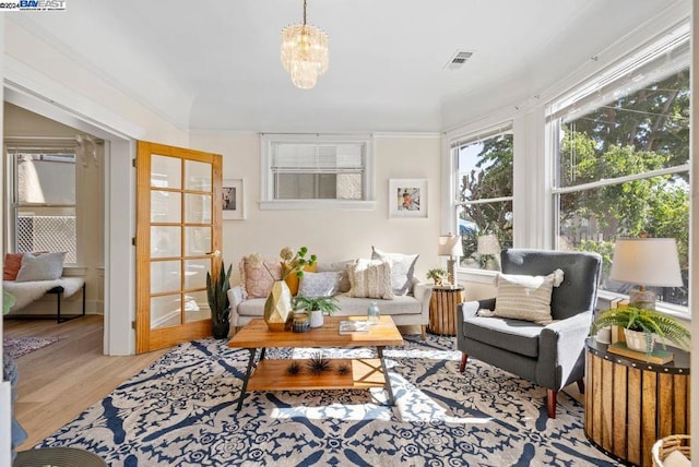 sunroom featuring a chandelier