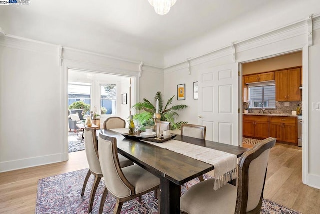 dining room with sink and light hardwood / wood-style flooring