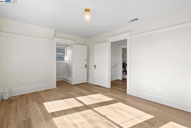 unfurnished bedroom with light wood-type flooring