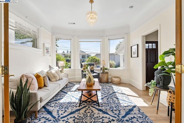 sunroom featuring an inviting chandelier