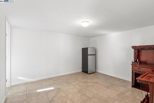 spare room featuring light tile patterned floors